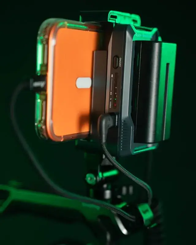 Accsoon Seemo with battery attached, holding an iPhone