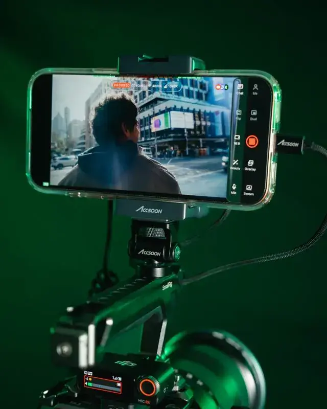 TVU Go running on an iPhone mounted on the Accsoon Seemo, above a caged Sony camera
